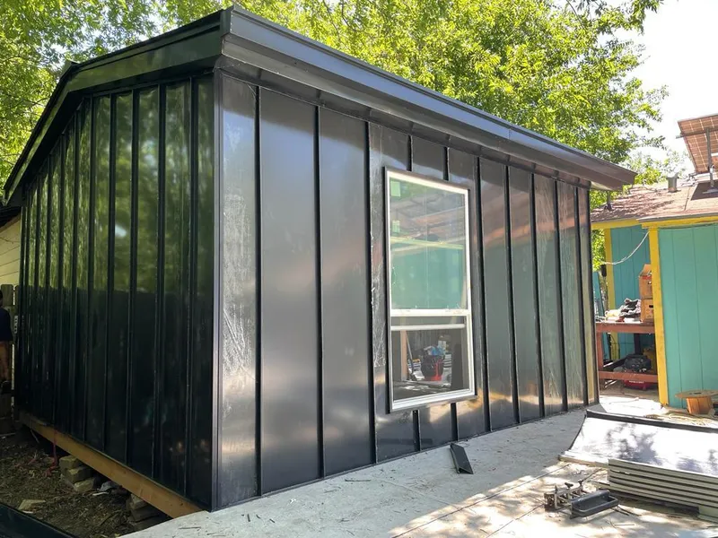 Black standing seam metal wall panels for Roof Inspection in Atkinson